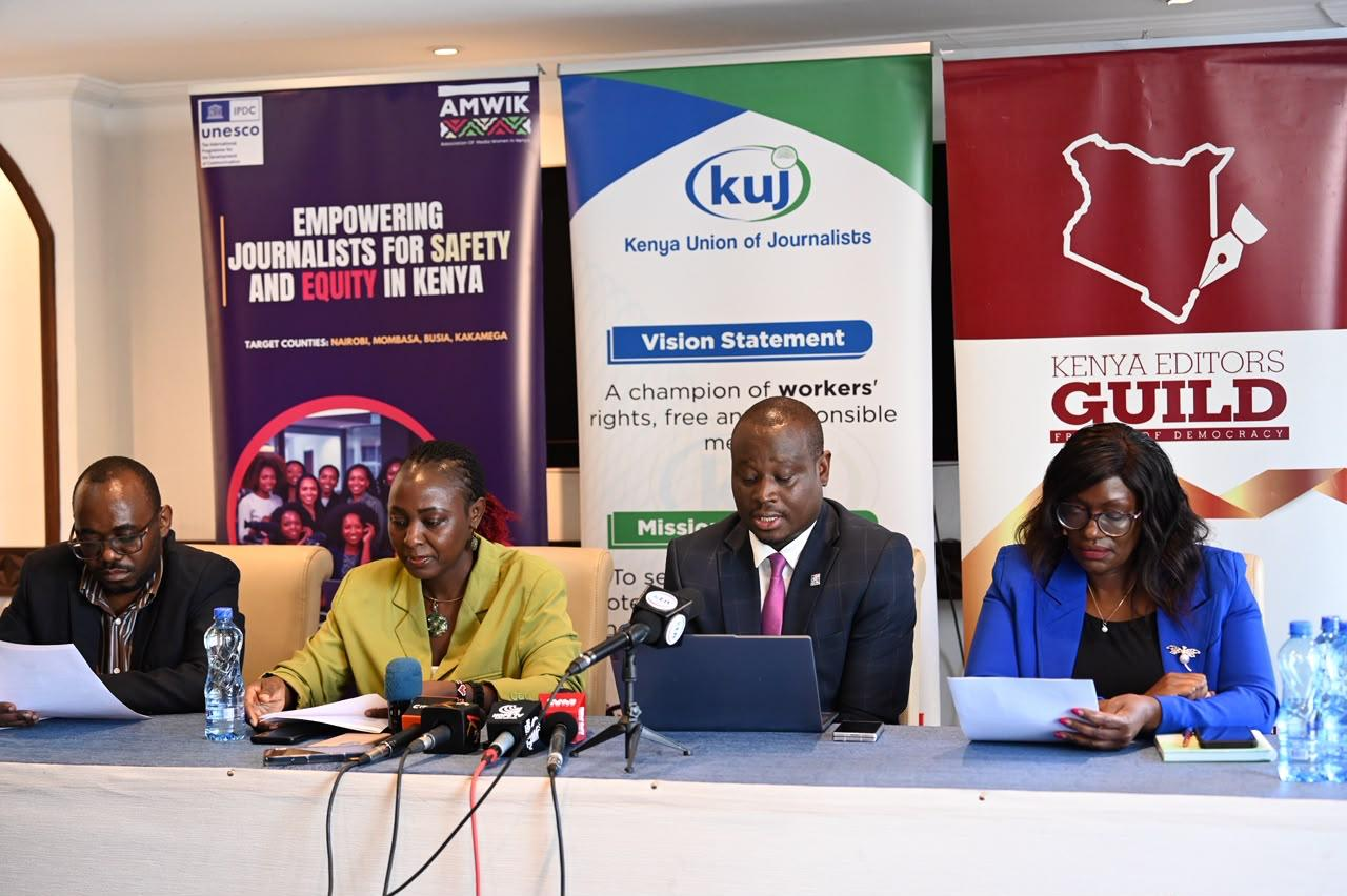 Speakers at a press conference table in front of Kenya Union of Journalists and Kenya Editors’ Guild banners